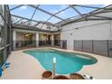 Inviting kidney-shaped swimming pool with a screened enclosure at 2556 Antlia Dr, Orlando, FL 32828