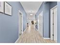 Light and bright hallway with light wood-look tile floors at 2639 Calistoga Ave, Kissimmee, FL 34741