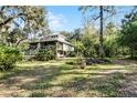 House with a large yard and mature trees surrounding at 2675 Van Arsdale St, Oviedo, FL 32765