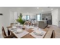 Open dining room with wooden table and view into kitchen at 2986 Salisbury Ave, Haines City, FL 33844