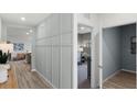 Light gray hallway with wood-look flooring and access to other rooms at 2986 Salisbury Ave, Haines City, FL 33844