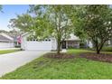 Two-car garage and neatly landscaped front yard at 3315 Newbliss Cir, Ormond Beach, FL 32174