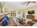 Inviting living room featuring a plush leather sofa, open layout, and seamless flow to the kitchen area at 5012 Shoreway Loop # 10207, Orlando, FL 32819