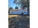 Rear view of the house showing a spacious backyard at 701 Titcomb St, Eustis, FL 32726