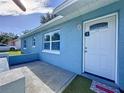 Front entrance of the house with a white door and small patio at 7211 Pinion Dr, Orlando, FL 32818