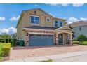 Two-story house with gray garage doors and stone accents at 7723 Graben St, Kissimmee, FL 34747