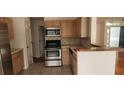 Galley kitchen with light wood cabinets and granite countertops at 7808 Rollingridge Ct, Orlando, FL 32835