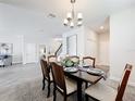 Formal dining room with chandelier and hardwood floors at 8886 Fallen Oak Dr, Davenport, FL 33896