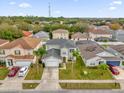 Two-story house, gray roof, driveway, and green lawn in a residential neighborhood at 1255 Blackwater Pond Dr, Orlando, FL 32828