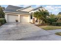 Two-car garage,palm trees, and neatly landscaped yard at 14087 Bradbury Rd, Orlando, FL 32828