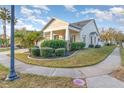 House exterior with two-car garage and manicured lawn at 14087 Bradbury Rd, Orlando, FL 32828