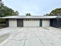 Three-car garage with new doors and driveway at 1933 Winnebago Trl, Fern Park, FL 32730