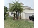 Two-story house with palm tree and landscaping at 209 San Carlo Rd, Davenport, FL 33896