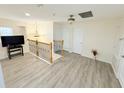 Upper hallway with wood-look flooring and two doors at 209 San Carlo Rd, Davenport, FL 33896