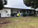 Screened porch and fenced backyard with landscaping at 250 Joanne Dr, Davenport, FL 33897