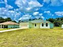 New construction home, light green exterior, two-car garage, and spacious yard at 2645 Sw 155Th Ln, Ocala, FL 34473