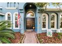 Elegant home exterior featuring a double door entry and manicured landscaping at 3063 Juneberry Ter, Oviedo, FL 32766