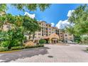 Condo building entrance with lush landscaping at 501 Mirasol Cir # 306, Celebration, FL 34747