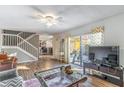 Bright living room with hardwood floors and a sliding glass door to the outdoor patio at 5368 Elm Ct # 354, Orlando, FL 32811