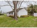 Side view of a single-story home showcasing the exterior and surrounding yard at 611 Bay Ave, Holly Hill, FL 32117