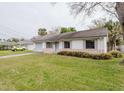 Single-story home featuring a well-kept lawn and landscaping in a quiet neighborhood at 611 Bay Ave, Holly Hill, FL 32117