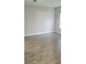 Empty living room with gray walls and wood-look tile floors at 615 N Delmonte Ct, Kissimmee, FL 34758