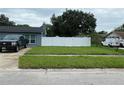 Large backyard with a white fence and a grassy area at 6642 Matchett Rd, Orlando, FL 32809