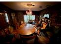 Dining room with hardwood floors, oval table, and floral wallpaper at 824 Lake Elbert Ct, Winter Haven, FL 33881