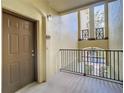 Interior hallway with brown doors and a view to the outside at 8276 Maritime Flag St # 201, Windermere, FL 34786