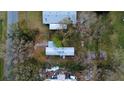 This aerial view shows the layout of the mobile home and its surrounding trees and yard at 9868 6Th Ave, Orlando, FL 32824