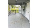 Covered front porch with bench and entrance door at 9868 6Th Ave, Orlando, FL 32824