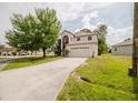 Charming two-story home featuring an attached two-car garage and well-maintained lawn at 1010 Embrun Ct, Kissimmee, FL 34759