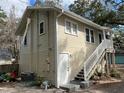 Low angle view of exterior, highlighting siding, windows, and stairs at 113 W 19Th St, Sanford, FL 32771