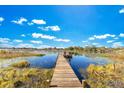 Serene lakefront property with a wooden dock at 1296 W Wellington Dr, Deltona, FL 32725