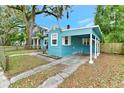 Light blue house with carport and a spacious yard at 1300 E Kaley St, Orlando, FL 32806