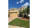 Two-story house with a large garage and landscaped yard at 14324 Fieldstone Lake Way, Orlando, FL 32824