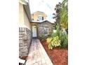 Inviting front entrance with a brick walkway and landscaping at 14324 Fieldstone Lake Way, Orlando, FL 32824