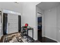 Bright entryway with dark hardwood floors and a view into a bedroom at 1501 Red Oak Ct, Apopka, FL 32703