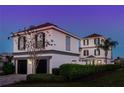 Stunning two-story home with gray accents and a two-car garage at 1549 Corolla Ct, Reunion, FL 34747