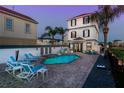 Inviting pool area with lounge chairs and a fire pit at 1549 Corolla Ct, Reunion, FL 34747