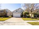 Charming one-story house featuring a paved driveway and landscaping at 16036 River Pointe Ct, Orlando, FL 32828