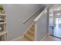 Straight staircase with carpeted steps and a neutral color scheme at 16583 Cedar Crest Dr, Orlando, FL 32828