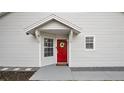 Red front door entry with a gray walkway and stone accents at 1659 Rivers Edge Dr, Orlando, FL 32825