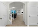 Bright entryway with tile flooring, and views into living and kitchen areas at 17066 Water Spring Blvd, Winter Garden, FL 34787