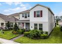 Two-story house with gray siding, brown shutters, and a landscaped front yard at 17066 Water Spring Blvd, Winter Garden, FL 34787