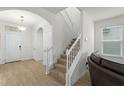 Staircase with white railing and carpeted steps in entryway at 17066 Water Spring Blvd, Winter Garden, FL 34787