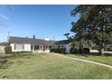 White house with red door and a walkway leading to the entrance at 2201 Sunderland Rd, Maitland, FL 32751