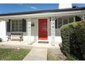 Red front door and white painted brick exterior at 2201 Sunderland Rd, Maitland, FL 32751