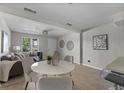 Open concept dining area with white round table and four light gray chairs at 2471 E 20Th St, Sanford, FL 32771