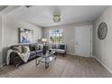 Bright living room with gray sofa, coffee table, and wood-look tile floors at 2471 E 20Th St, Sanford, FL 32771